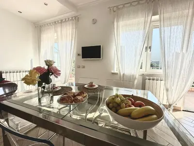 a room with a glass table with a bowl of fruit at Terrazza sul Parco in Rome