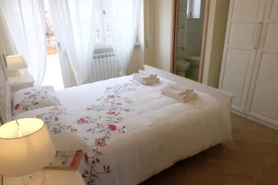 a bedroom with a white bed with flowers on it at Terrazza sul Parco in Rome
