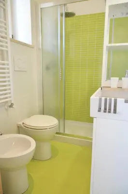 a bathroom with a toilet and a sink and a shower at Terrazza sul Parco in Rome