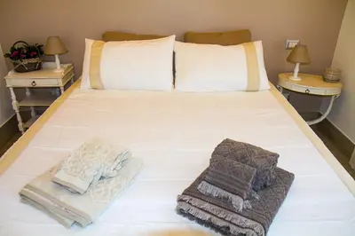 a bed with towels on it with two night stands at Si.Ca.Li. al Vaticano in Rome