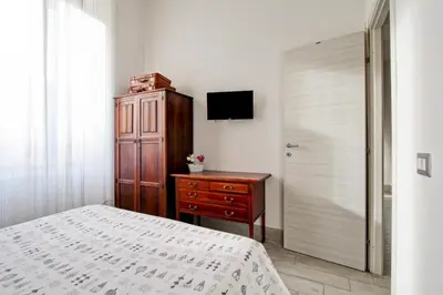 a bedroom with a bed and a dresser and a television at Si.Ca.Li. al Vaticano in Rome