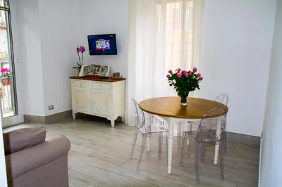 a dining room with a table with a vase of flowers on it at Si.Ca.Li. al Vaticano in Rome