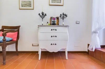 a living room with a white couch and a table at Purificazione 44 Guest House in Rome