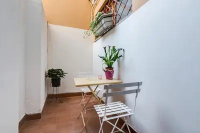 a bedroom with a bed and a dresser and a chair at Purificazione 44 Guest House in Rome