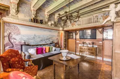 a bedroom with a large bed in a room filled with books at Campo De Fiori Baroque in Rome