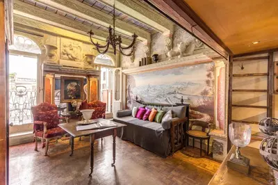 a bedroom with a bed in a room with bookshelves at Campo De Fiori Baroque in Rome