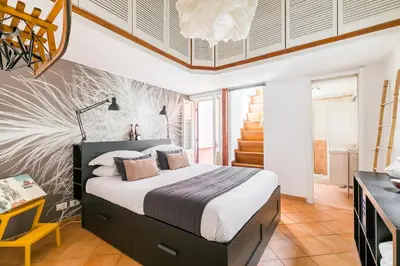 a bedroom with a bed in a room with a staircase at Xystum in Rome