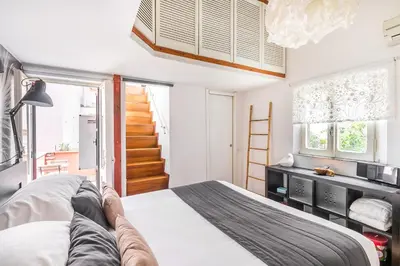 a bedroom with a bed and a staircase at Xystum in Rome
