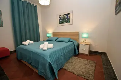a bedroom with a blue bed with towels on it at Flaminio Butterfly House in Rome