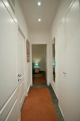 a hallway with white walls and an orange tile floor at Flaminio Butterfly House in Rome