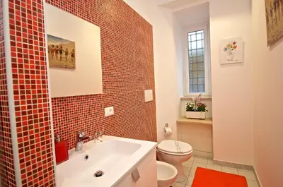 a bathroom with a white sink and a toilet at Flaminio Butterfly House in Rome