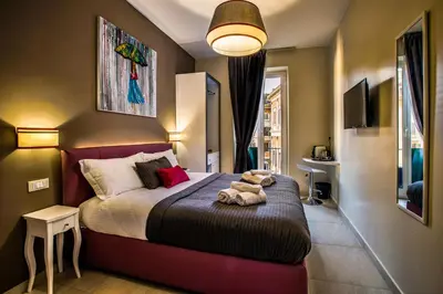 a bedroom with a bed with a teddy bear on it at Guest House Grazioli in Rome