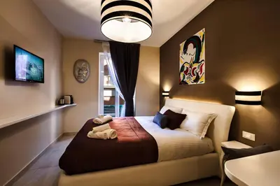 a bedroom with a bed with a stuffed animal on it at Guest House Grazioli in Rome