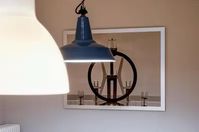 a blue pendant light in a room with a picture at Fotofever Apt, two bedrooms with air conditioned in elegant shopping area, close to Vatican City in Rome