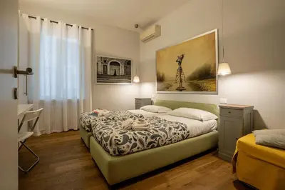 a bedroom with a bed and a painting on the wall at Fotofever Apt, two bedrooms with air conditioned in elegant shopping area, close to Vatican City in Rome
