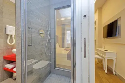 a bathroom with a shower with a glass door at Alla Locanda Malandra in Rome