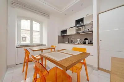 a kitchen and dining room with a table and chairs at Alla Locanda Malandra in Rome