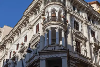 a building with a balcony on the side of it at Donna Margherita Rome Suite & Rooms in Rome