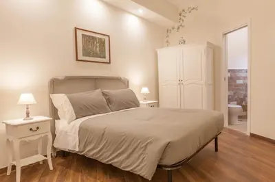 a bedroom with a large bed and two night stands at Donna Margherita Rome Suite & Rooms in Rome