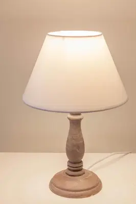 a lamp with a white lamp shade on a table at Donna Margherita Rome Suite & Rooms in Rome