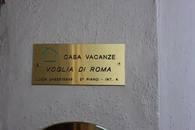 a sign on the ceiling of a room at Casa Vacanze Voglia di Roma in Rome