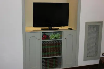 a tv on top of a cabinet with a tv at Casa Vacanze Voglia di Roma in Rome