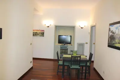 a dining room with a table and a tv at Casa Vacanze Voglia di Roma in Rome
