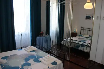 a bedroom with a mirror and a bed with towels at Casa Vacanze Voglia di Roma in Rome