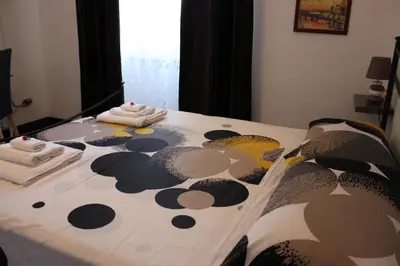 a bedroom with a bed with a polka dot blanket at Casa Vacanze Voglia di Roma in Rome