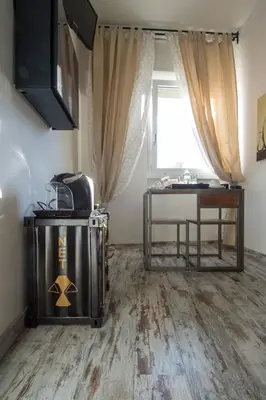 a room with a desk and a table and a window at Letto e Latte Roma Guest House in Rome