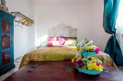 a bedroom with a bed with flowers on a table at Letto e Latte Roma Guest House in Rome