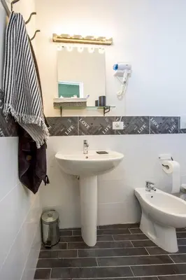 a bathroom with a sink and a toilet at Letto e Latte Roma Guest House in Rome