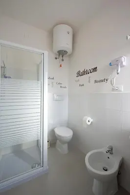 a bathroom with a shower and a toilet and a sink at Letto e Latte Roma Guest House in Rome