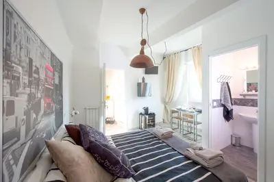 a living room with a couch with pillows on it at Letto e Latte Roma Guest House in Rome