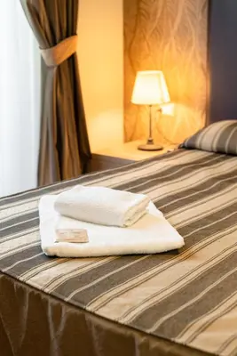 a pair of towels sitting on top of a bed at Dreams Roma B&B in Rome