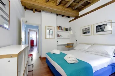 a bedroom with a large bed and a desk at YCH-Farnese Charme in Rome