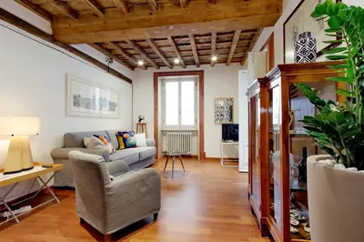 a living room with a couch and a chair at YCH-Farnese Charme in Rome