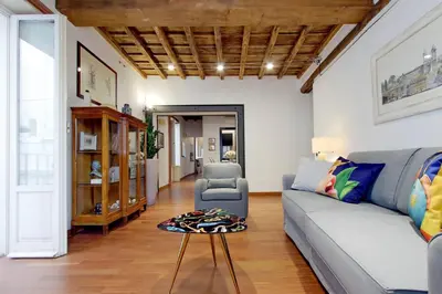 a living room with a couch and a table at YCH-Farnese Charme in Rome