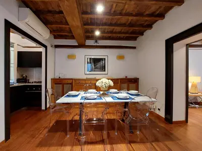 a dining room with a table and chairs at YCH-Farnese Charme in Rome