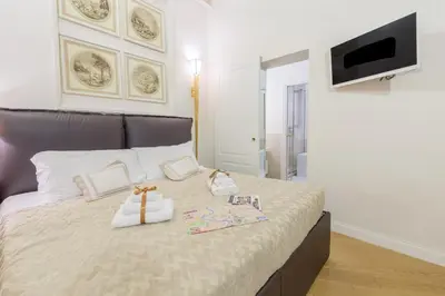 a bedroom with a bed with two bags on it at StarHome Pantheon in Rome