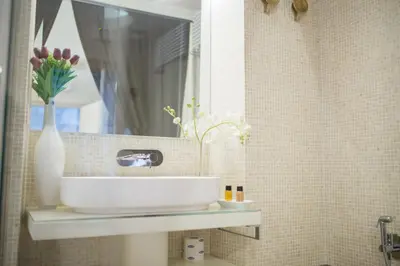 a bathroom with a white sink and a mirror at StarHome Pantheon in Rome