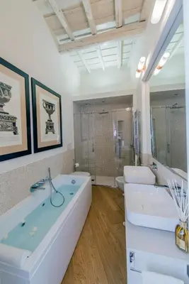 a bathroom with two sinks and a tub and a shower at StarHome Pantheon in Rome