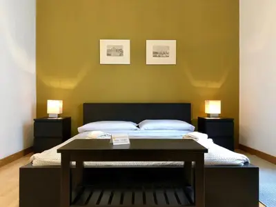a bedroom with a bed with two lamps on the wall at Monti Friendly Rome House in Rome