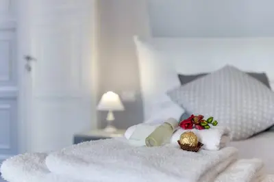 a bed with towels and candles on top of it at Trevi Luxury Maison in Rome