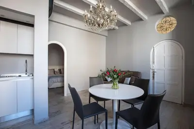 a dining room with a white table and chairs at Trevi Luxury Maison in Rome