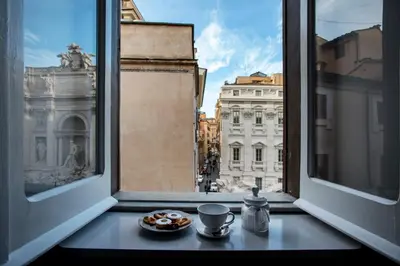 a view of the city from an open window at Trevi Luxury Maison in Rome