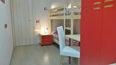 a small room with a desk and bunk beds at Romulea Guest House in Rome
