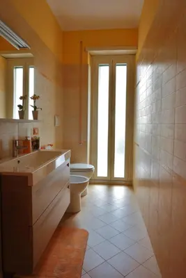 a bathroom with a sink and a toilet and a window at La Casa di Emma a Trastevere in Rome