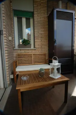 a wooden bench sitting in front of a building at La Casa di Emma a Trastevere in Rome