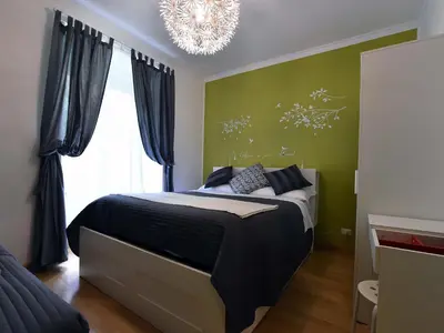 a bedroom with a bed and a chandelier at Jubilee 2 in Rome